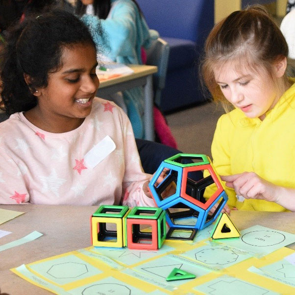 Two girls playing with Magnetic Polydron